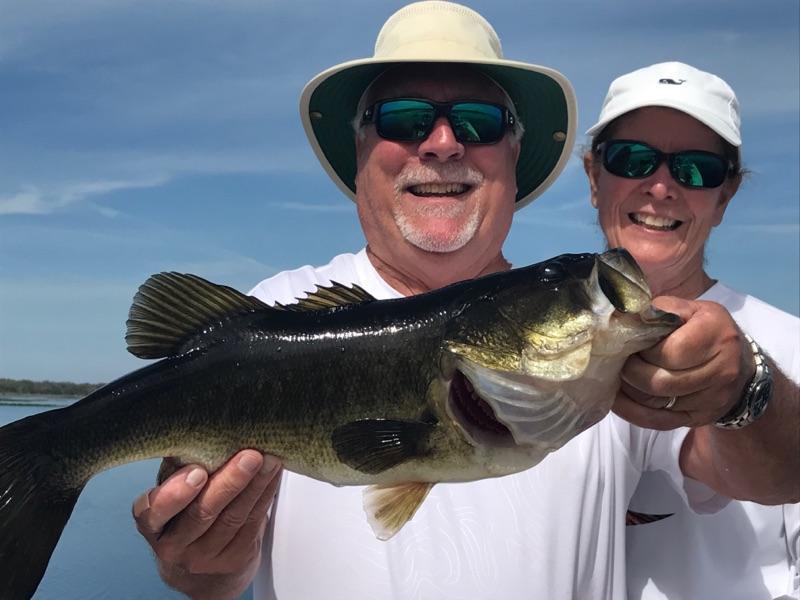 Happy couple holding a trophy largemouth bass on Lake Toho