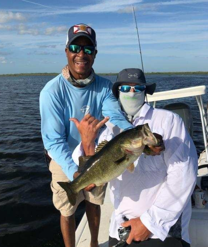 Fisherman holding a 16-inch bass in Kissimmee